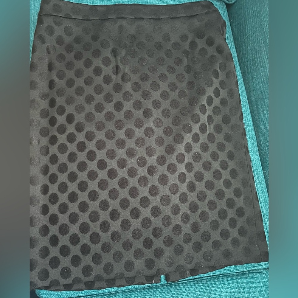 Black on black polka dot skirt.
